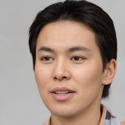 Joyful asian young-adult male with short  brown hair and brown eyes