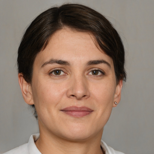 Joyful white adult female with short  brown hair and brown eyes