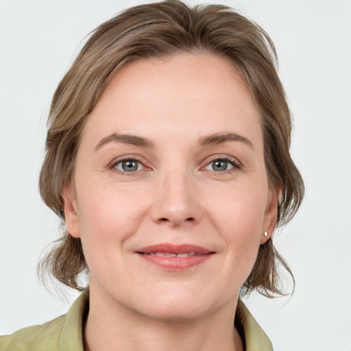 Joyful white young-adult female with medium  brown hair and blue eyes