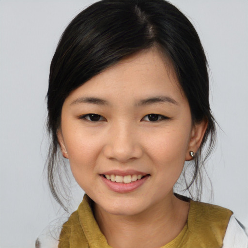 Joyful asian young-adult female with medium  brown hair and brown eyes