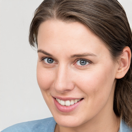 Joyful white young-adult female with medium  brown hair and blue eyes