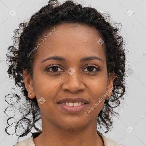 Joyful black young-adult female with long  brown hair and brown eyes