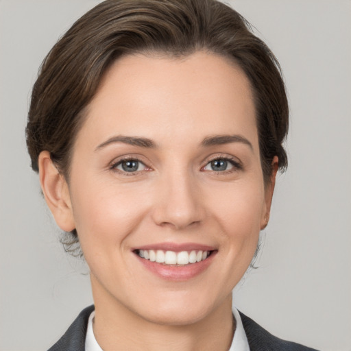 Joyful white young-adult female with short  brown hair and grey eyes