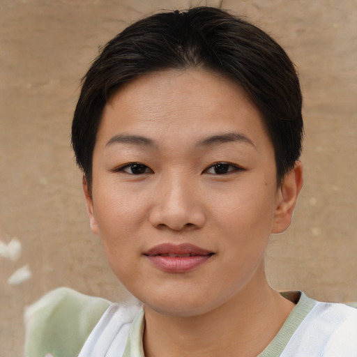 Joyful asian young-adult female with short  brown hair and brown eyes