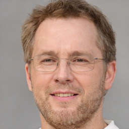 Joyful white middle-aged male with short  brown hair and brown eyes