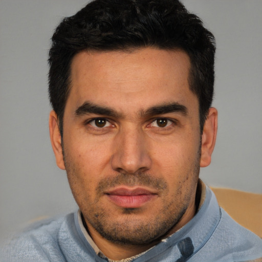 Joyful white young-adult male with short  black hair and brown eyes
