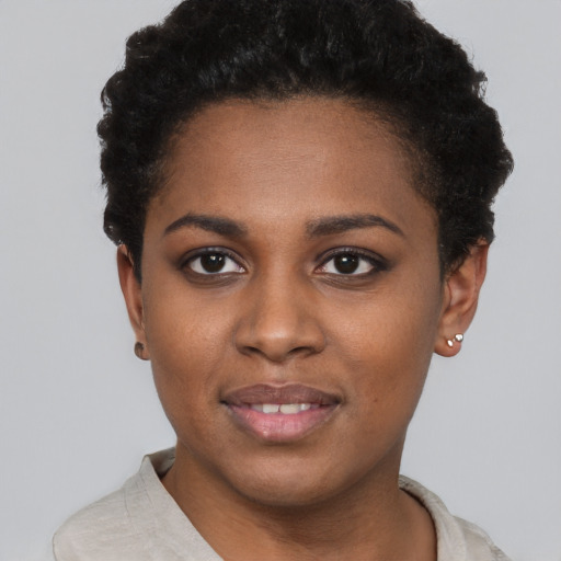 Joyful black young-adult female with short  brown hair and brown eyes