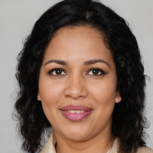 Joyful latino adult female with long  brown hair and brown eyes
