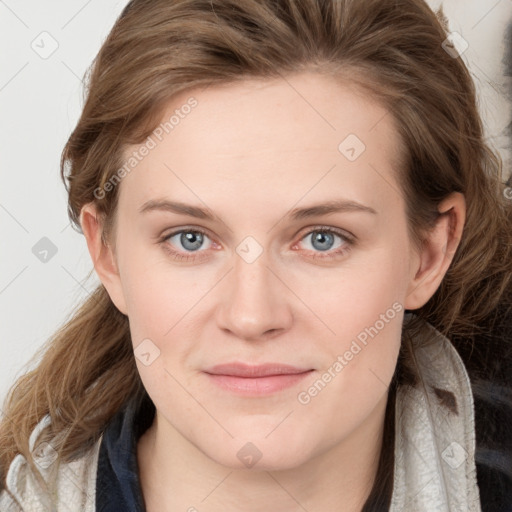 Joyful white young-adult female with long  brown hair and blue eyes