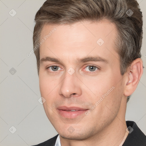 Joyful white young-adult male with short  brown hair and brown eyes