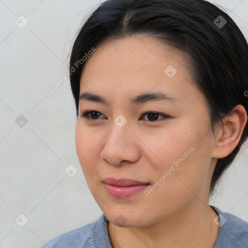 Joyful asian young-adult female with short  brown hair and brown eyes