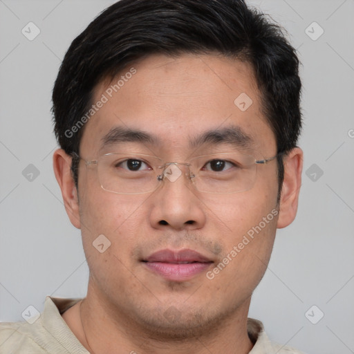 Joyful asian young-adult male with short  brown hair and brown eyes