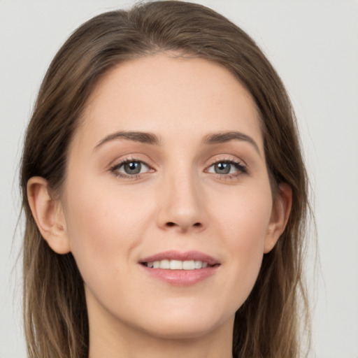 Joyful white young-adult female with long  brown hair and grey eyes