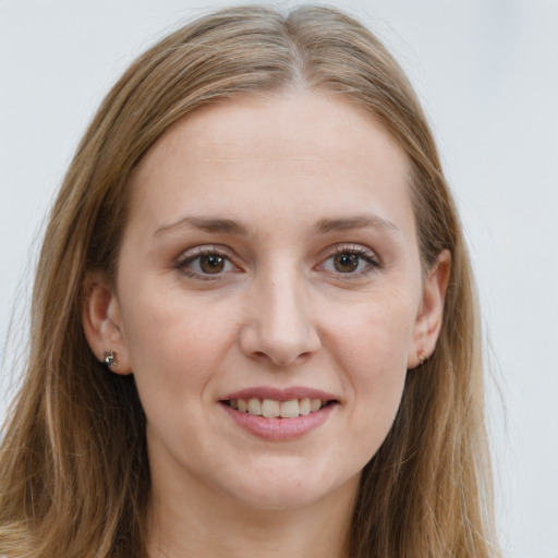 Joyful white young-adult female with long  brown hair and grey eyes