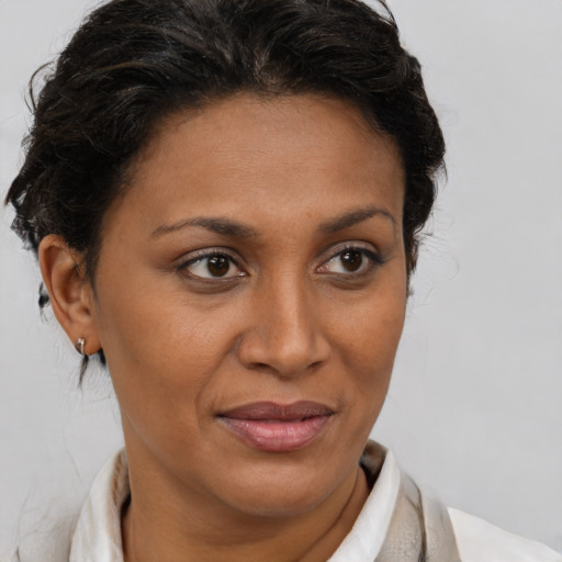 Joyful latino adult female with short  brown hair and brown eyes