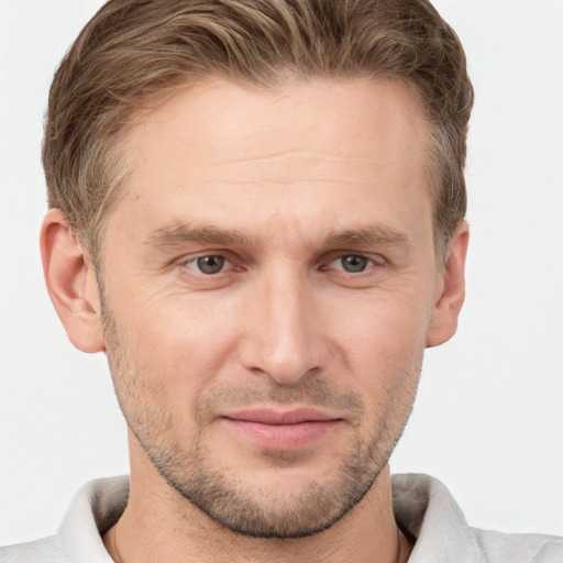 Joyful white adult male with short  brown hair and grey eyes