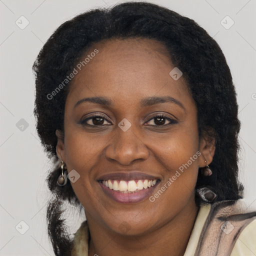 Joyful black adult female with long  brown hair and brown eyes