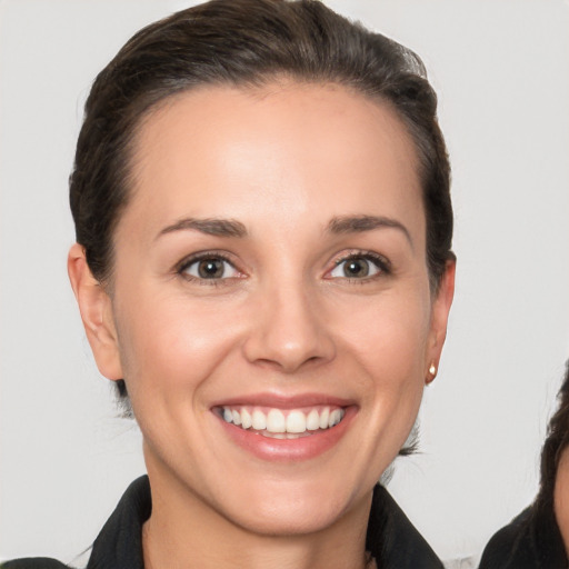 Joyful white young-adult female with short  brown hair and brown eyes