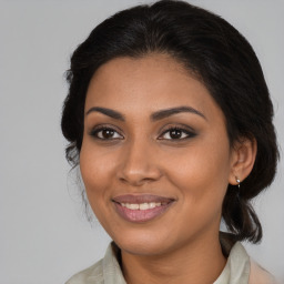 Joyful black young-adult female with medium  brown hair and brown eyes