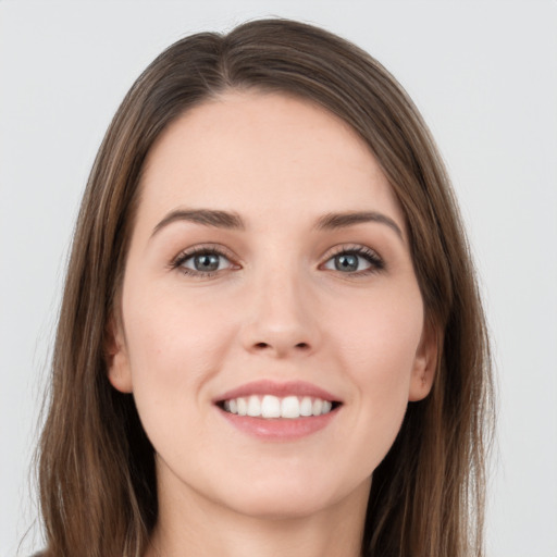 Joyful white young-adult female with long  brown hair and grey eyes