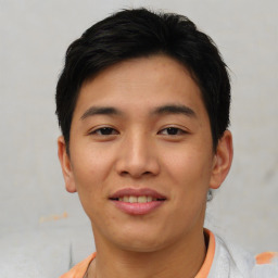 Joyful asian young-adult male with short  brown hair and brown eyes