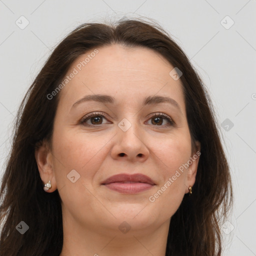 Joyful white adult female with long  brown hair and brown eyes