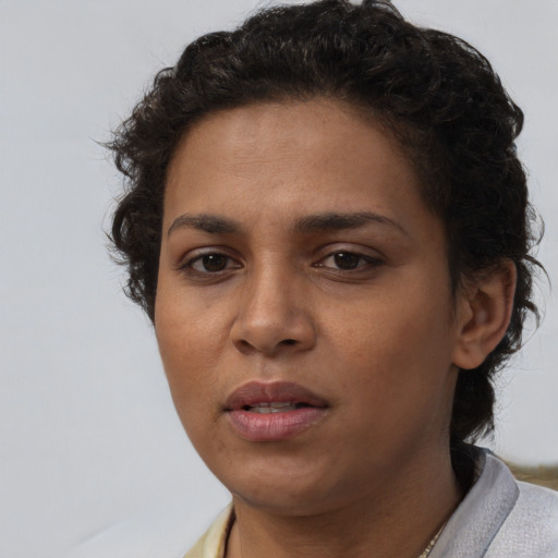 Joyful latino young-adult female with short  brown hair and brown eyes