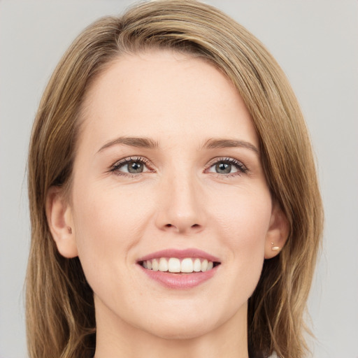 Joyful white young-adult female with medium  brown hair and green eyes