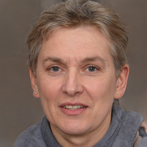 Joyful white middle-aged female with short  brown hair and brown eyes