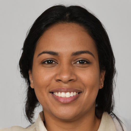 Joyful black young-adult female with medium  black hair and brown eyes