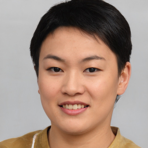 Joyful asian young-adult female with short  brown hair and brown eyes
