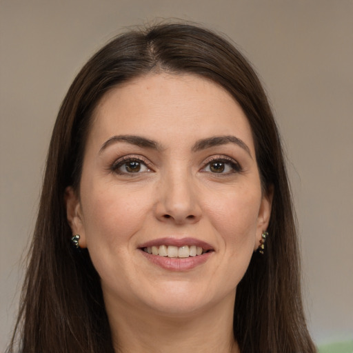 Joyful white young-adult female with long  brown hair and brown eyes