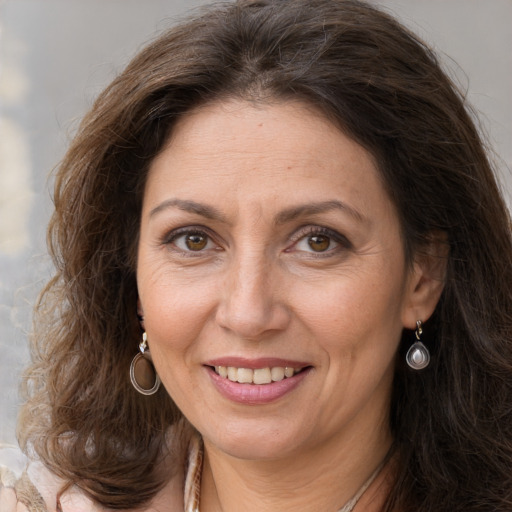 Joyful white adult female with long  brown hair and brown eyes