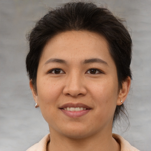 Joyful asian adult female with medium  brown hair and brown eyes