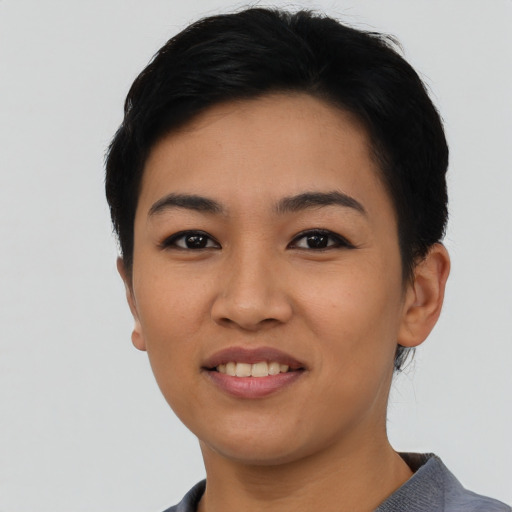 Joyful asian young-adult female with short  black hair and brown eyes