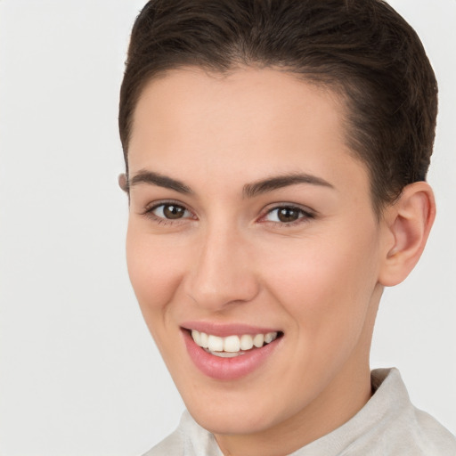 Joyful white young-adult female with short  brown hair and brown eyes