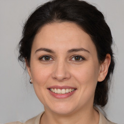 Joyful white adult female with medium  brown hair and brown eyes