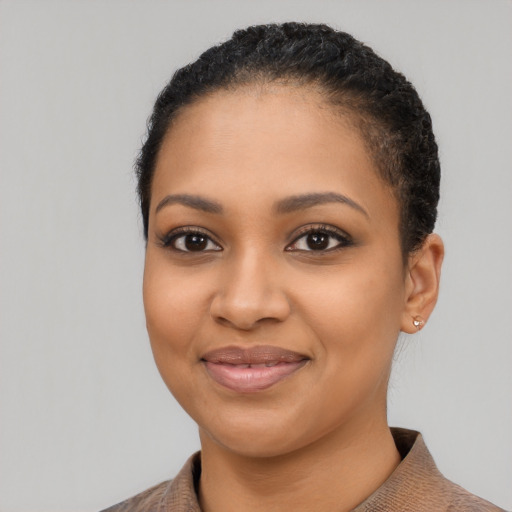 Joyful latino young-adult female with short  black hair and brown eyes
