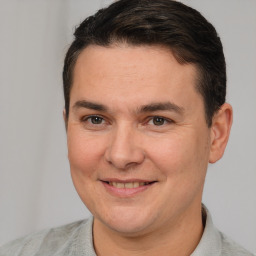 Joyful white adult male with short  brown hair and brown eyes