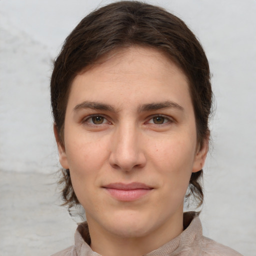 Joyful white young-adult female with medium  brown hair and grey eyes