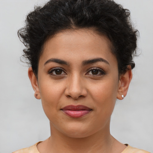 Joyful latino young-adult female with short  brown hair and brown eyes