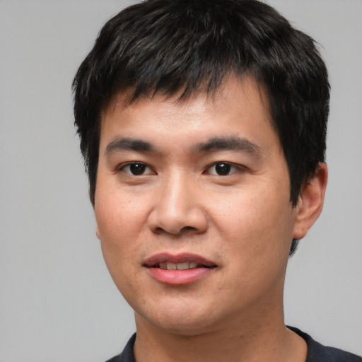 Joyful asian young-adult male with short  black hair and brown eyes
