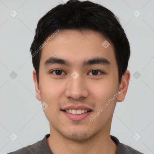 Joyful asian young-adult male with short  black hair and brown eyes