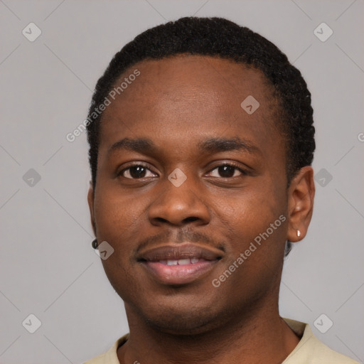 Joyful black young-adult male with short  black hair and brown eyes