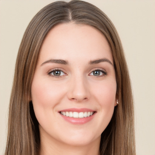 Joyful white young-adult female with long  brown hair and brown eyes