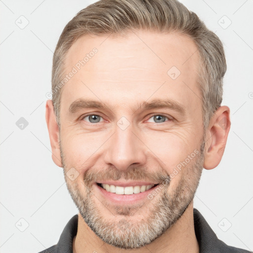 Joyful white adult male with short  brown hair and grey eyes