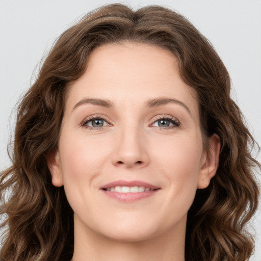 Joyful white young-adult female with long  brown hair and green eyes