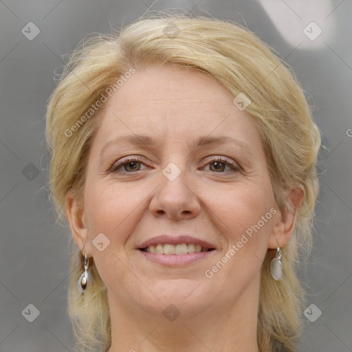 Joyful white adult female with medium  brown hair and grey eyes