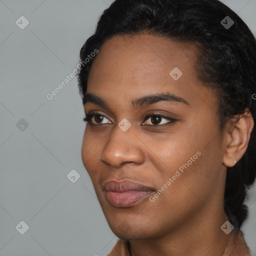 Joyful black young-adult female with short  black hair and brown eyes