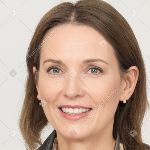 Joyful white adult female with medium  brown hair and grey eyes